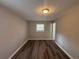 Bright bedroom with neutral paint, wood-look floors, a window and an access door at 3900 Boulder Park Sw Dr, Atlanta, GA 30331