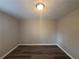 Empty bedroom featuring neutral paint, wood-look floors, and a simple ceiling light at 3900 Boulder Park Sw Dr, Atlanta, GA 30331