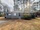 Charming one-story home featuring a gray brick facade, well-maintained landscaping, and inviting entrance at 3900 Boulder Park Sw Dr, Atlanta, GA 30331
