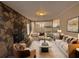 Comfortable living room featuring a stone accent wall, plush seating, and modern decor at 3900 Boulder Park Sw Dr, Atlanta, GA 30331