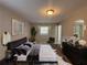 Stylishly staged main bedroom features modern furnishings and decor, with ample natural light and wood-look flooring at 3900 Boulder Park Sw Dr, Atlanta, GA 30331