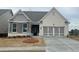 Charming single-Gathering home featuring a brick and stone facade, complemented by a well-manicured lawn at 822 Kestrel Dr, Loganville, GA 30052