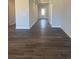 Inviting hallway featuring wood-look floors, crisp white trim, and a view of the front door at 822 Kestrel Dr, Loganville, GA 30052
