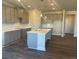 Bright kitchen featuring a spacious island, quartz countertops, stylish pendant lights, and stainless-steel appliances at 822 Kestrel Dr, Loganville, GA 30052