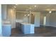 Open-concept kitchen with an island, modern cabinetry, stainless steel sink, and elegant pendant lighting at 822 Kestrel Dr, Loganville, GA 30052
