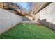 Artificial grass in the backyard with a retaining wall and fence, with steps leading to an upper level at 2983 Crosswycke Forest Ne Dr # A, Atlanta, GA 30319