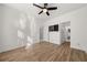 This bright bedroom features wood floors, a ceiling fan and a door to the en-suite bathroom at 2983 Crosswycke Forest Ne Dr # A, Atlanta, GA 30319