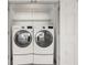 This laundry closet features a side-by-side washer and dryer, with additional shelving at 2983 Crosswycke Forest Ne Dr # A, Atlanta, GA 30319