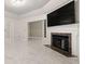 Spacious living room with fireplace, marble floors, and a large television above the mantel at 2983 Crosswycke Forest Ne Dr # A, Atlanta, GA 30319