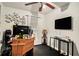 Small bedroom has black carpet, a ceiling fan, and desk setup at 338 Saratoga Pl, Riverdale, GA 30296