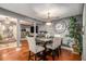 Open dining area with hardwood floors, stylish lighting, and access to living room at 338 Saratoga Pl, Riverdale, GA 30296