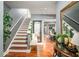 Entryway with hardwood floors and staircase leads to dining area at 338 Saratoga Pl, Riverdale, GA 30296