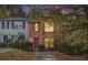 The front of the home is warmly lit with curb appeal at 338 Saratoga Pl, Riverdale, GA 30296