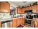 Functional kitchen with stainless steel appliances and wooden cabinets at 338 Saratoga Pl, Riverdale, GA 30296