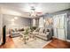 Cozy living room with hardwood floors, ceiling fan, and comfortable seating at 338 Saratoga Pl, Riverdale, GA 30296