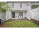 A back patio features space for seating and access to the home at 338 Saratoga Pl, Riverdale, GA 30296