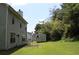 A spacious backyard with a shed, patio furniture, lush grass, and green trees at 5627 Isleworth Ct, Atlanta, GA 30349