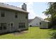 View of a large backyard featuring a shed, green lawn, and small patio with an outdoor seating area at 5627 Isleworth Ct, Atlanta, GA 30349
