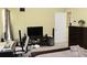 Bedroom features a TV, desk, entertainment center, and light, neutral colored walls at 5627 Isleworth Ct, Atlanta, GA 30349