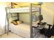 Bedroom featuring a metal bunk bed with a desk, chair, computer, and light, neutral colored walls at 5627 Isleworth Ct, Atlanta, GA 30349