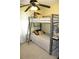 A bedroom featuring a metal bunk bed with a desk, ceiling fan, and light, neutral colored walls at 5627 Isleworth Ct, Atlanta, GA 30349
