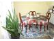 Cozy dining table set for four, complemented by a rug, plants, and neutral decor at 5627 Isleworth Ct, Atlanta, GA 30349