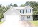 Charming two-story home with gray siding, green shutters, attached two-car garage, and small front yard at 5627 Isleworth Ct, Atlanta, GA 30349