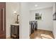 Well-lit laundry room and half bath featuring modern washer and dryer units, stylish vanity, and hardwood floors at 4664 Brunning Ct, Atlanta, GA 30338