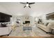 Bright living room with stone fireplace, ceiling fan, large TV and neutral decor at 4664 Brunning Ct, Atlanta, GA 30338