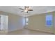 Spacious main bedroom featuring light wood floors, a ceiling fan, and plenty of natural light from two windows at 983 Oakwood Chase Cir, Stone Mountain, GA 30083