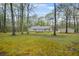 Spacious backyard with mature trees and a detached garage at 125 Bridget Dr, Hampton, GA 30228