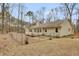 Fenced backyard of home with deck and wooded area at 125 Bridget Dr, Hampton, GA 30228