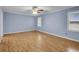 Large bedroom featuring hardwood floors, two windows, and neutral paint at 125 Bridget Dr, Hampton, GA 30228