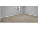 Bedroom with neutral carpet and a window, offering a bright and simple space at 125 Bridget Dr, Hampton, GA 30228