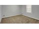 Bedroom with neutral carpet and a window, offering a cozy and simple space at 125 Bridget Dr, Hampton, GA 30228