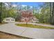 Ranch style home and detached garage with a decorative tree in the front yard at 125 Bridget Dr, Hampton, GA 30228