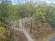 Exterior view of a home with mature trees and a long driveway at 125 Bridget Dr, Hampton, GA 30228