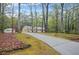 Ranch style home with red shutters is surrounded by mature trees at 125 Bridget Dr, Hampton, GA 30228