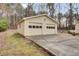 Spacious detached two-car garage with large driveway and trees at 125 Bridget Dr, Hampton, GA 30228