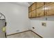 Laundry room featuring a water heater, tile floors and white walls at 125 Bridget Dr, Hampton, GA 30228