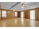 Open concept living room featuring paneled walls, ceiling fans, and wood floors at 125 Bridget Dr, Hampton, GA 30228