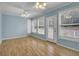 Sunroom with many windows letting in lots of natural light and hardwood floors at 125 Bridget Dr, Hampton, GA 30228