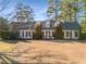 Charming one-story brick home featuring a manicured lawn, mature trees and black shutters at 2249 Chadds Creek Dr, Marietta, GA 30062