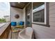 Cozy balcony features vibrant blue planters, a charming sun decoration, and a comfortable chair to enjoy the outdoors at 3785 Allegretto Cir # 230, Atlanta, GA 30339