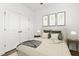 A staged bedroom with a neutral color palette and natural light at 3785 Allegretto Cir # 230, Atlanta, GA 30339