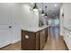 Kitchen island features stone countertops, stainless steel appliances, pendant lighting, and views into the living area at 3785 Allegretto Cir # 230, Atlanta, GA 30339