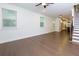 Open-concept living space with hardwood floors, ample natural light, and a seamless transition to the staircase and kitchen at 3785 Allegretto Cir # 230, Atlanta, GA 30339