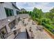 Expansive outdoor patio features ample seating, a built-in grill, and views of the surrounding lush greenery at 3785 Allegretto Cir # 230, Atlanta, GA 30339