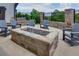 Inviting patio features comfortable seating arranged around a stone fire pit, perfect for outdoor relaxation and entertaining at 3785 Allegretto Cir # 230, Atlanta, GA 30339