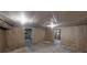 Open unfinished basement area showing walls with insulation and views into other spaces at 170 Den Ric Dr, Mcdonough, GA 30253